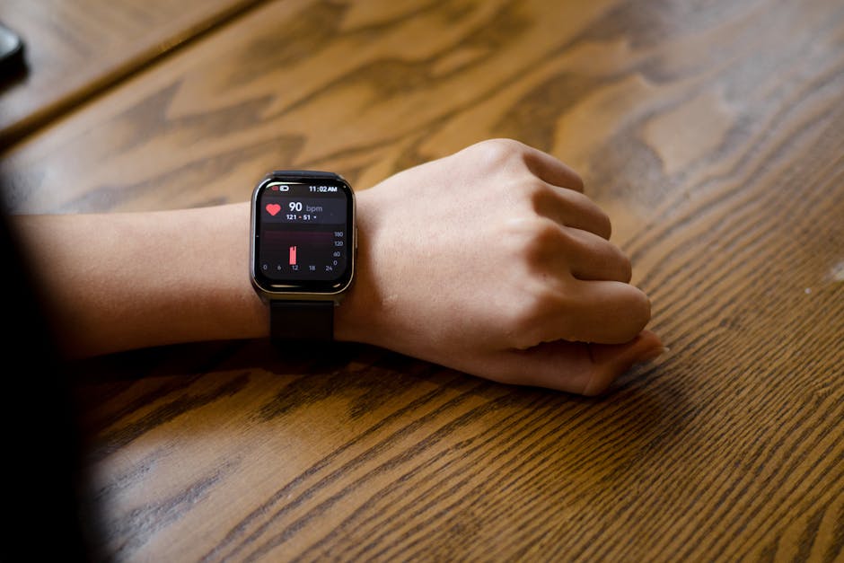 Close-up of a wrist wearable showing a heart-rate reading at 104 bpm, illustrating how HRV is captured by consumer smart rings and watches