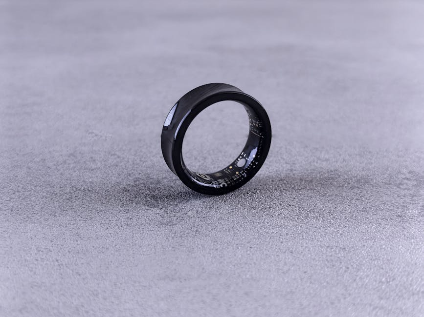 Close-up of a titanium smart ring showing the inner sensor face that houses the photoplethysmography LEDs.